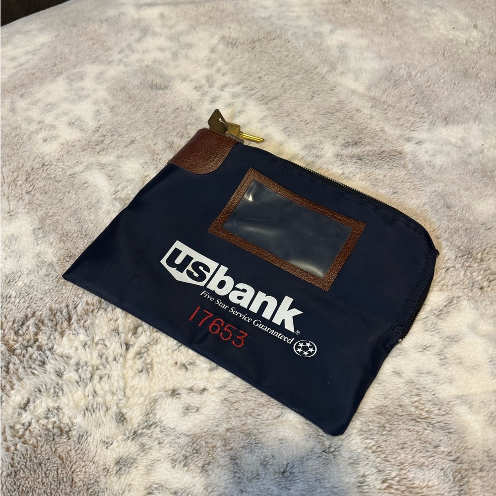 Locking bank deposit bag with keys.